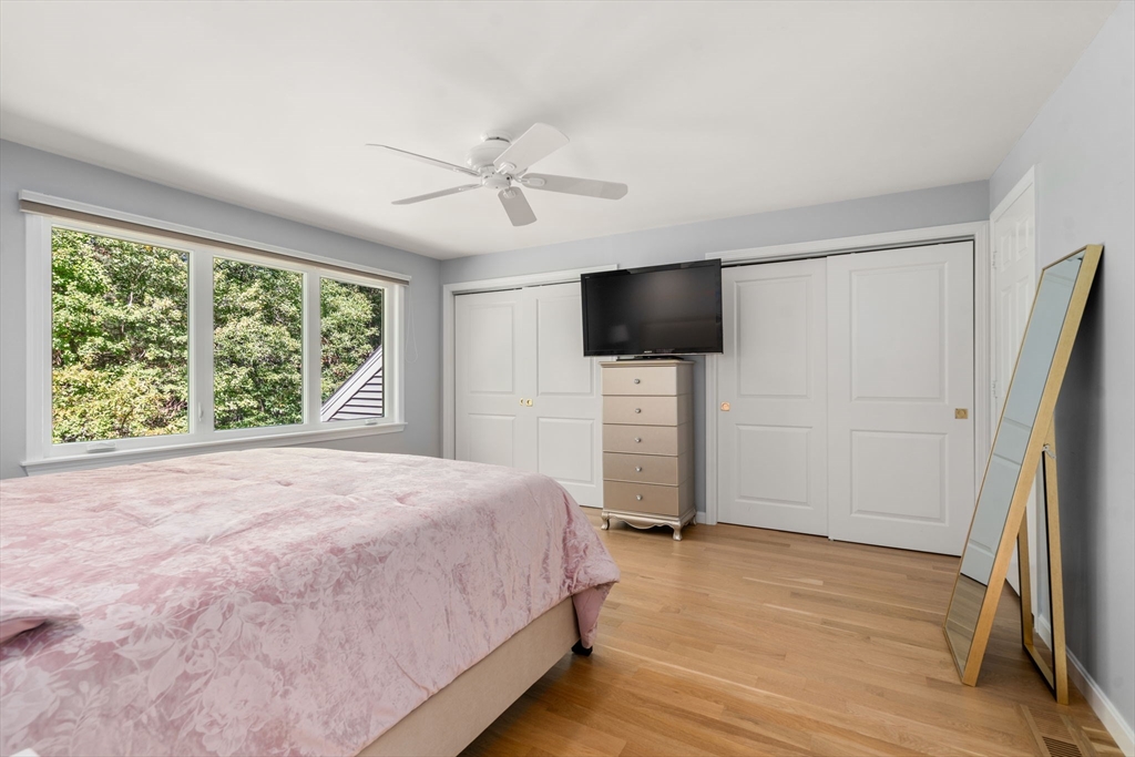 16 Coltsway, Unit 16 Wayland, MA 01778 - Photo 15 of 29 a bedroom with a bed and a flat screen tv
