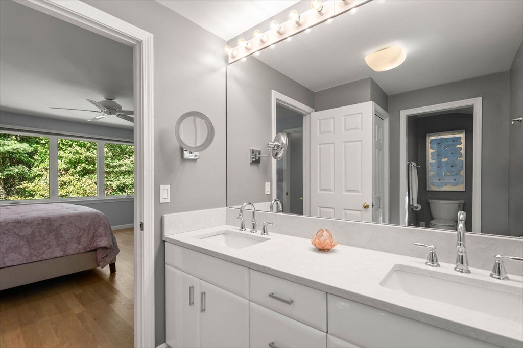 16 Coltsway, Unit 16 Wayland, MA 01778 - Photo 16 of 29 a bathroom with a double vanity sink and a mirror