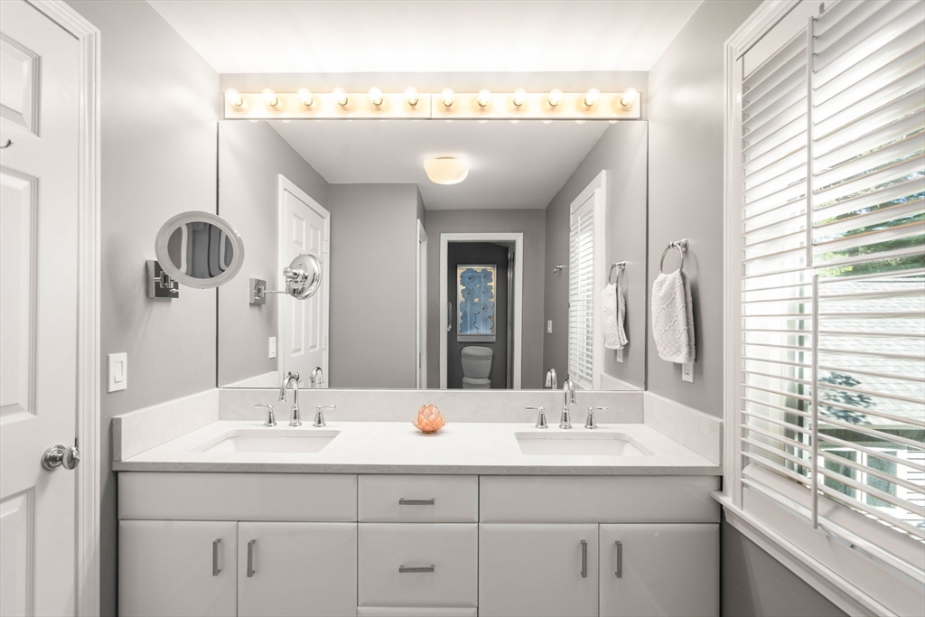 16 Coltsway, Unit 16 Wayland, MA 01778 - Photo 17 of 29 a bathroom with a sink and a mirror