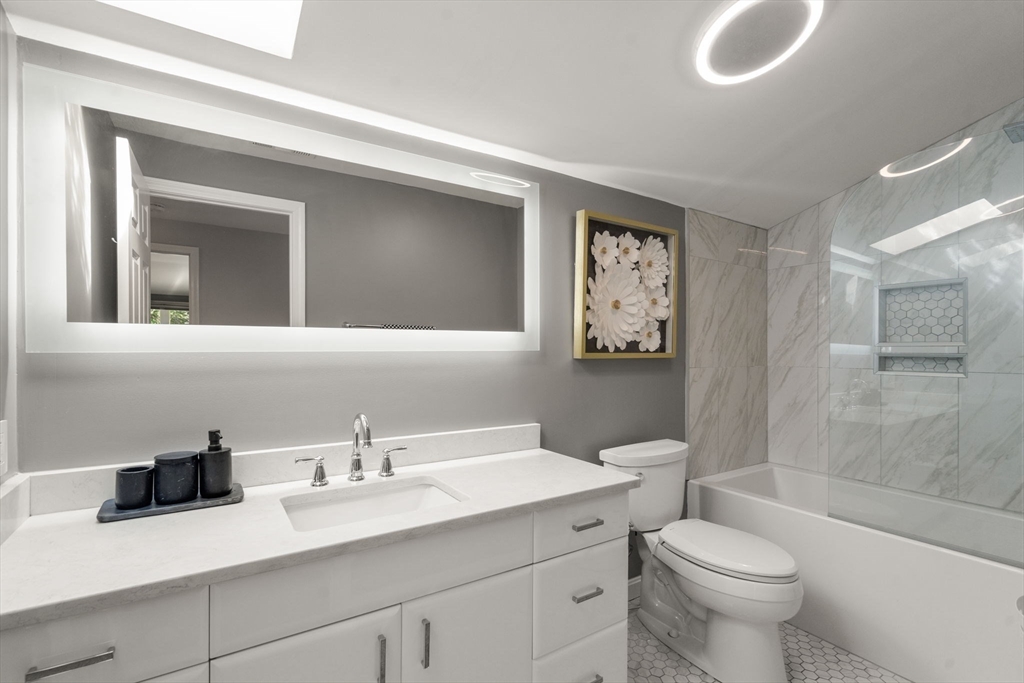 16 Coltsway, Unit 16 Wayland, MA 01778 - Photo 18 of 29 a bathroom with a sink a toilet and shower