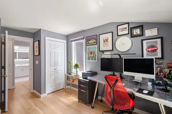 a view of a workspace with furniture and a flat screen tv