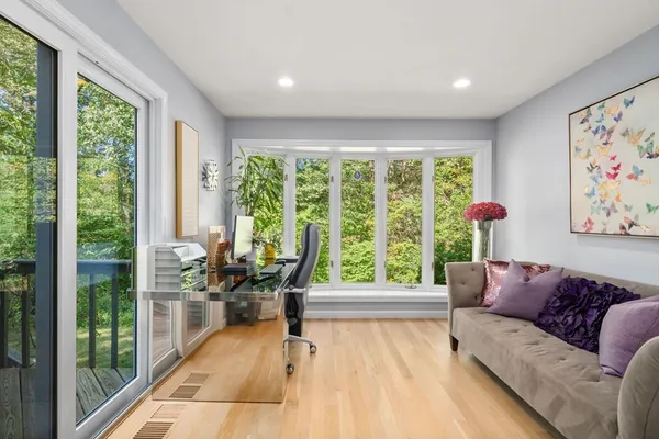 a living room with furniture and large windows