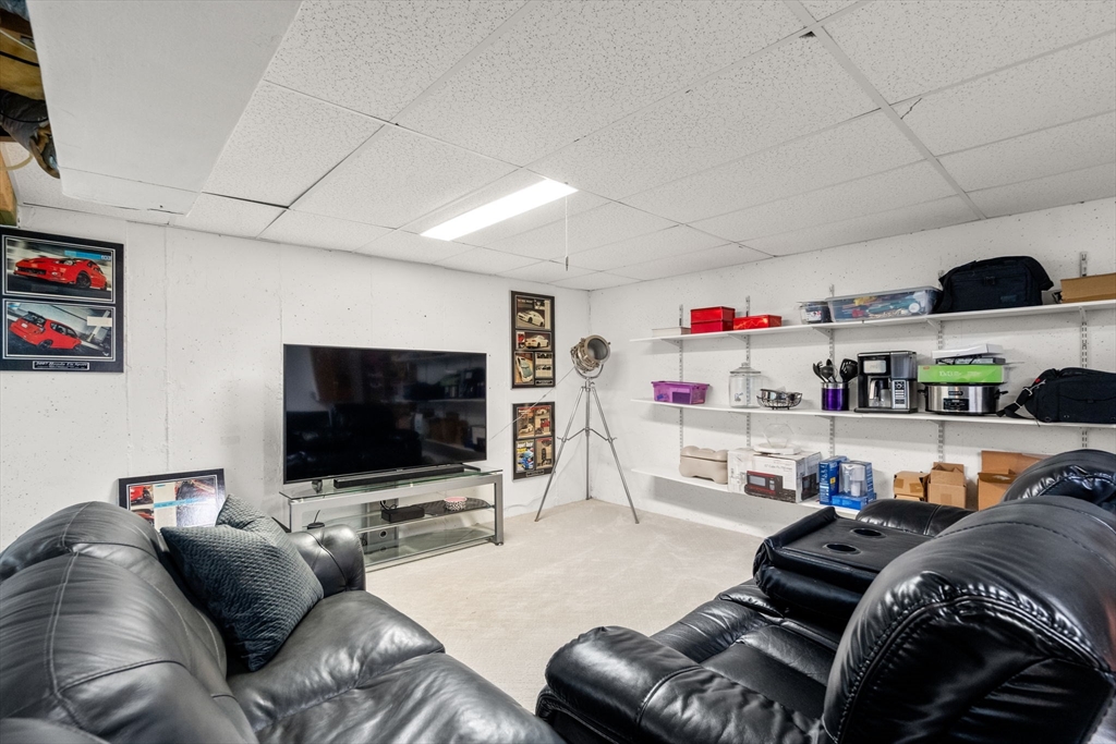 16 Coltsway, Unit 16 Wayland, MA 01778 - Photo 24 of 29 a living room with furniture and a flat screen tv