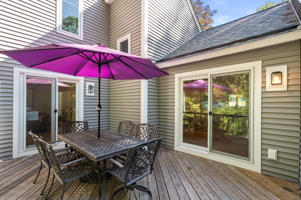 16 Coltsway, Unit 16 Wayland, MA 01778 - Photo 26 of 29 an outdoor space with furniture and umbrella