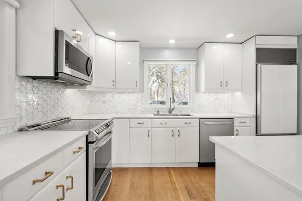 a kitchen with a sink stove and refrigerator