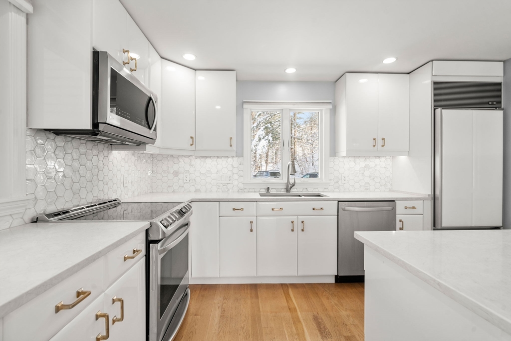 16 Coltsway, Unit 16 Wayland, MA 01778 - Photo 5 of 29 a kitchen with a sink stove and refrigerator