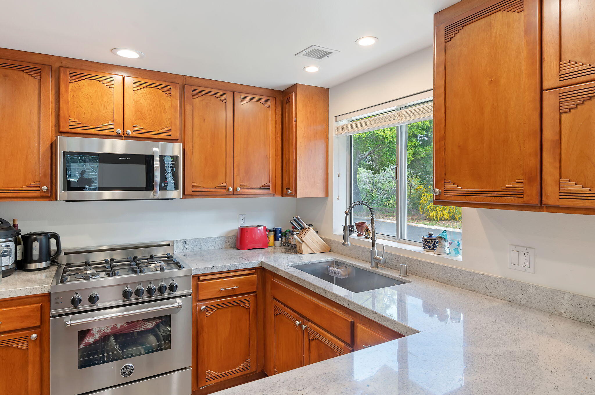 419 Barling Terrace Goleta, CA 93117 - Photo 6 of 17 a kitchen with stainless steel appliances wooden cabinets and a stove top oven