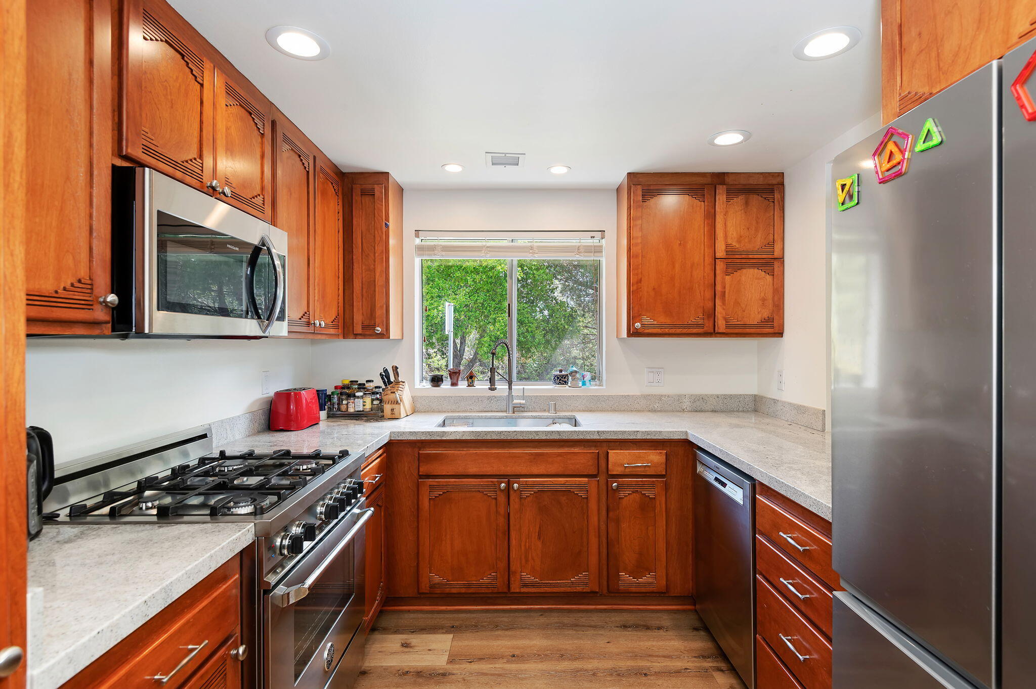 419 Barling Terrace Goleta, CA 93117 - Photo 7 of 17 a kitchen with stainless steel appliances granite countertop a stove a sink dishwasher and a microwave oven with cabinets