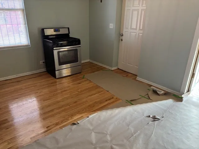a view of a room with wooden floor and white walls