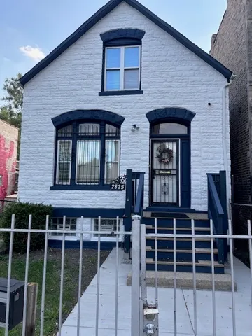 a front view of a house with large windows