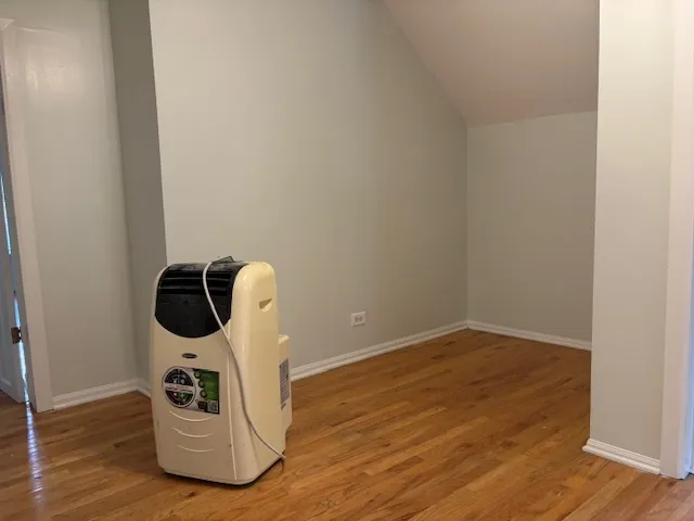 a utility room with wooden floor washer and dryer