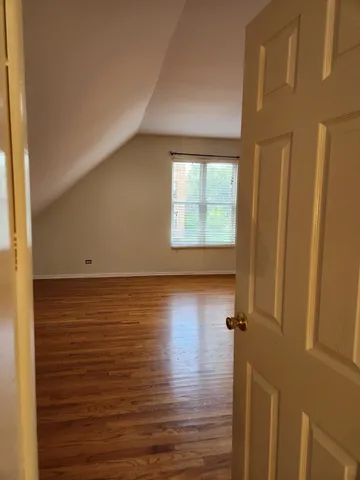 a view of room with window and wooden floor