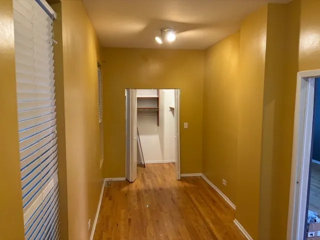 a view of a hallway with wooden floor