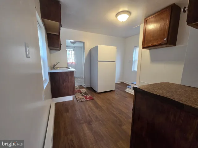 a view of kitchen with furniture and wooden floor