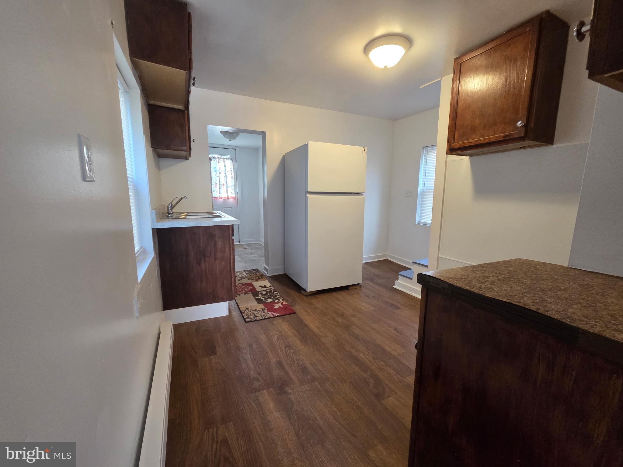 909 Pine Street Cambridge, MD 21613 - Photo 7 of 19 a view of kitchen with furniture and wooden floor