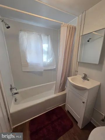 a bathroom with a sink a mirror and a bathtub