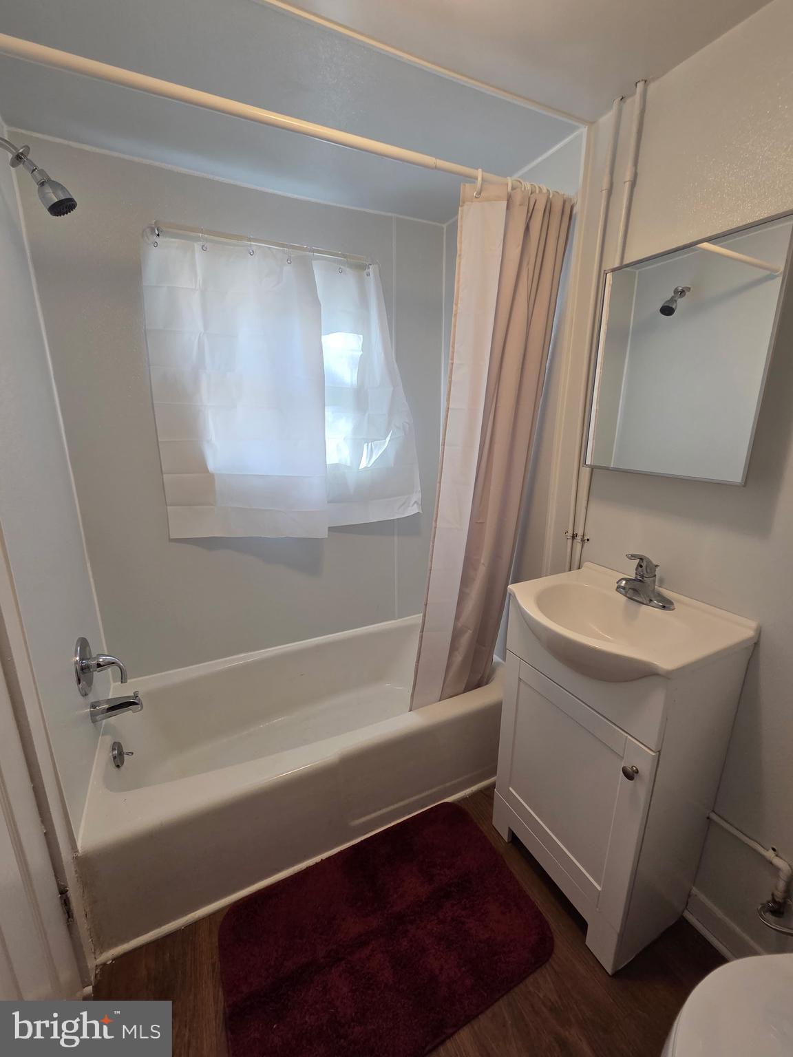 909 Pine Street Cambridge, MD 21613 - Photo 8 of 19 a bathroom with a sink a mirror and a bathtub