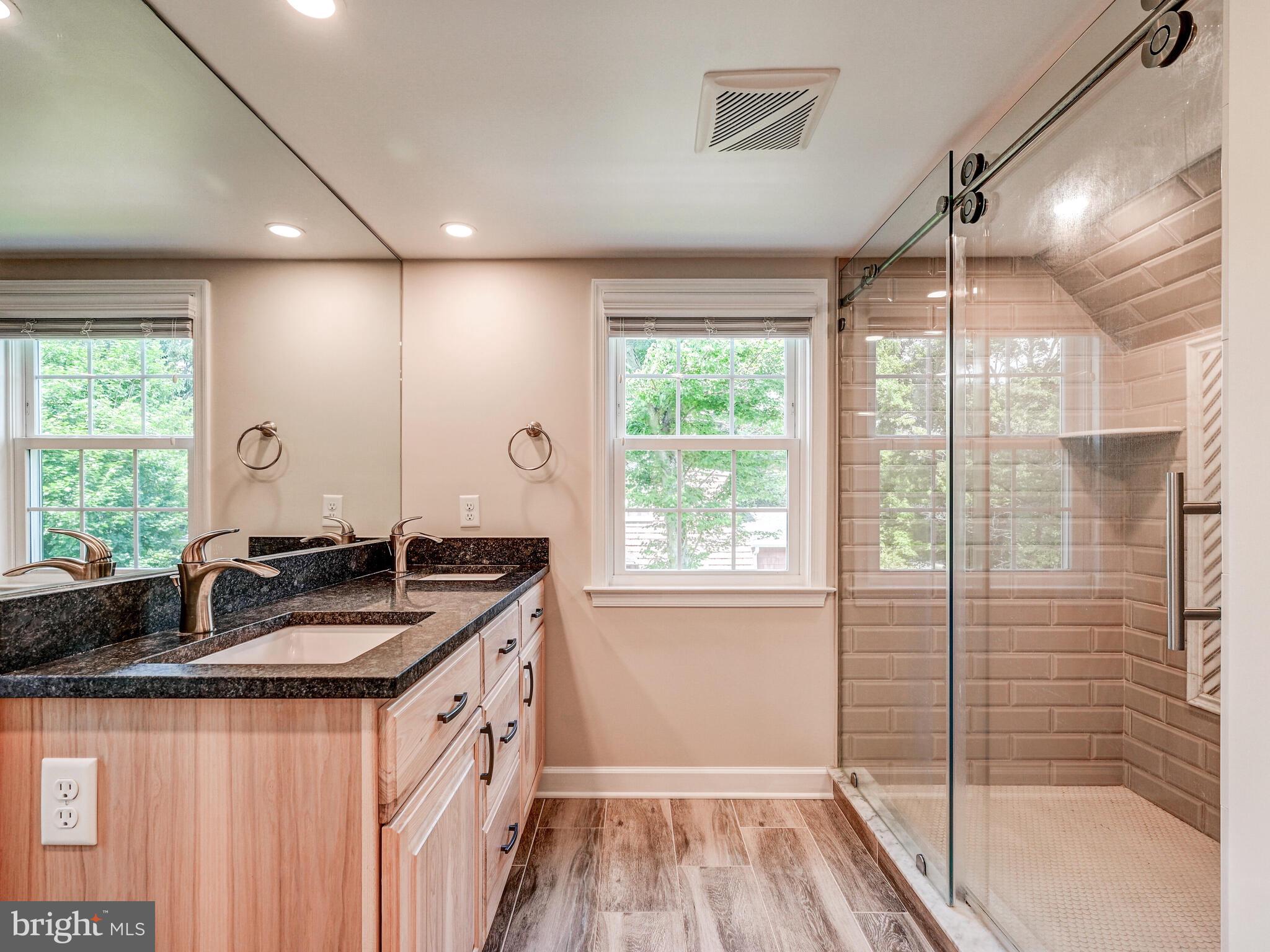 3322 Hess Road Monkton, MD 21111 - Photo 13 of 22 a bathroom with a granite countertop sink a toilet a mirror and next to a window