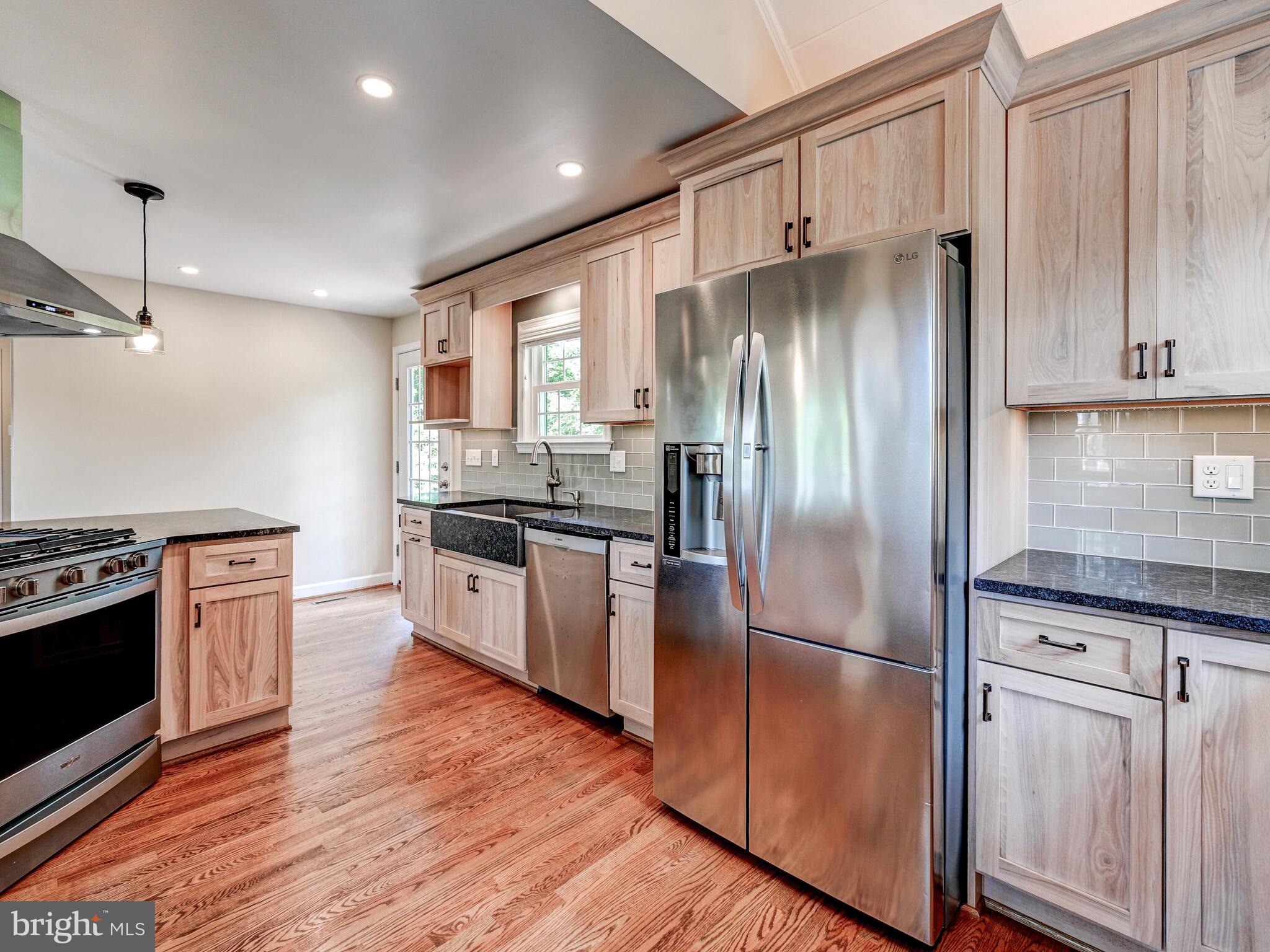 3322 Hess Road Monkton, MD 21111 - Photo 21 of 22 a kitchen with granite countertop stainless steel appliances a refrigerator cabinets and wooden floor