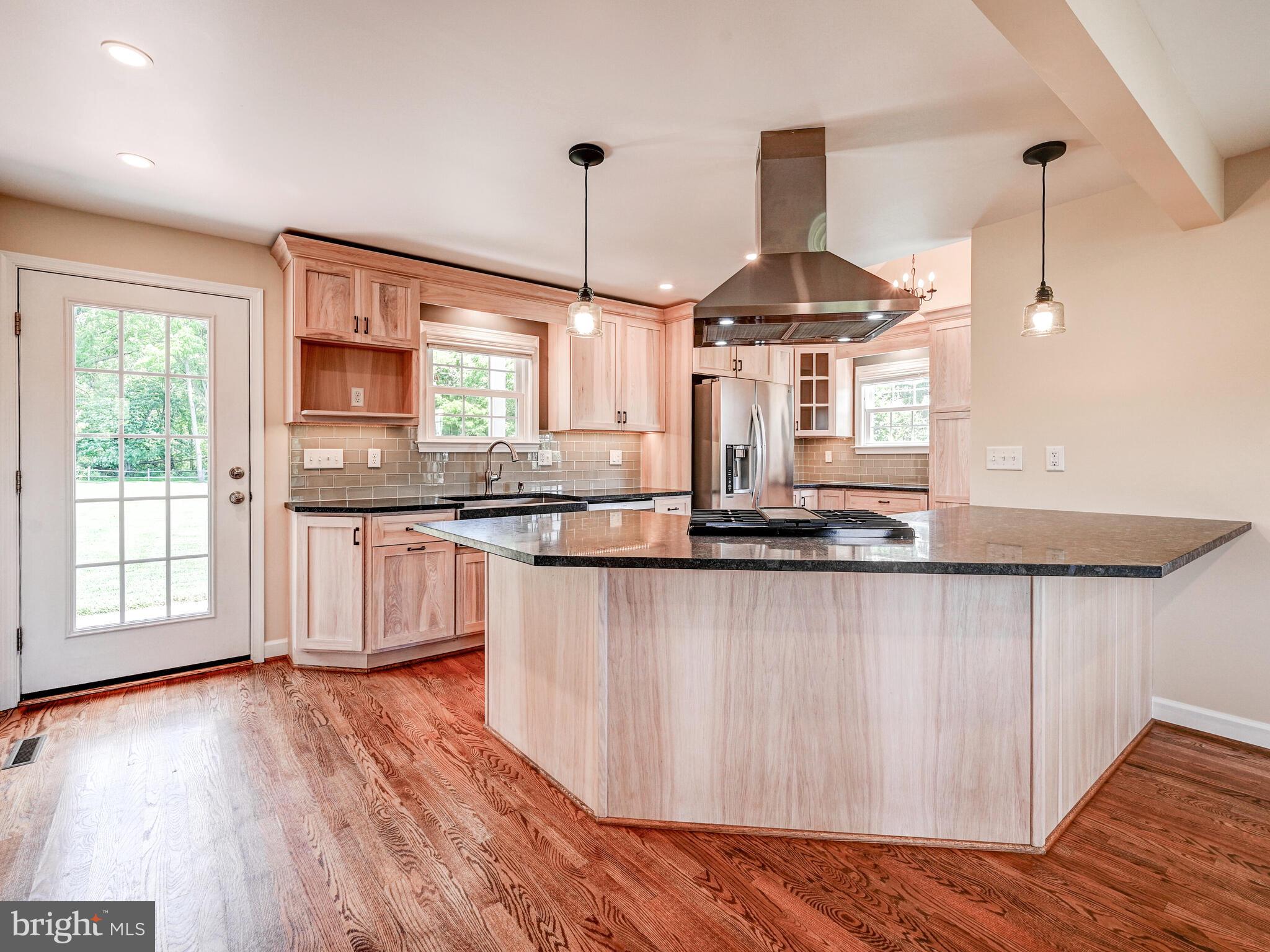 3322 Hess Road Monkton, MD 21111 - Photo 5 of 22 a kitchen with stainless steel appliances granite countertop wooden floors and white cabinets