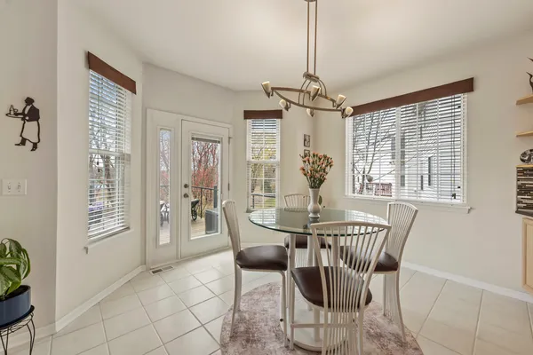 a living room with furniture and a dining table with rug