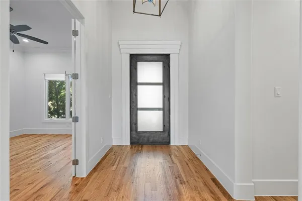 a view of a room with wooden floor and a window