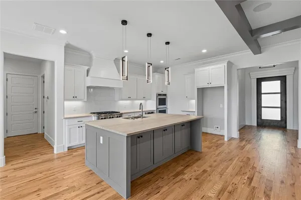 a kitchen with stainless steel appliances granite countertop a stove and a refrigerator