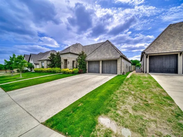 a view of a house with a big yard plants and large trees