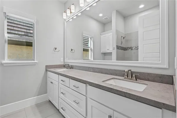 a bathroom with a sink double vanity and a mirror