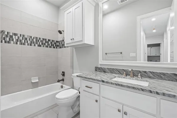 a bathroom with a sink a toilet and bathtub