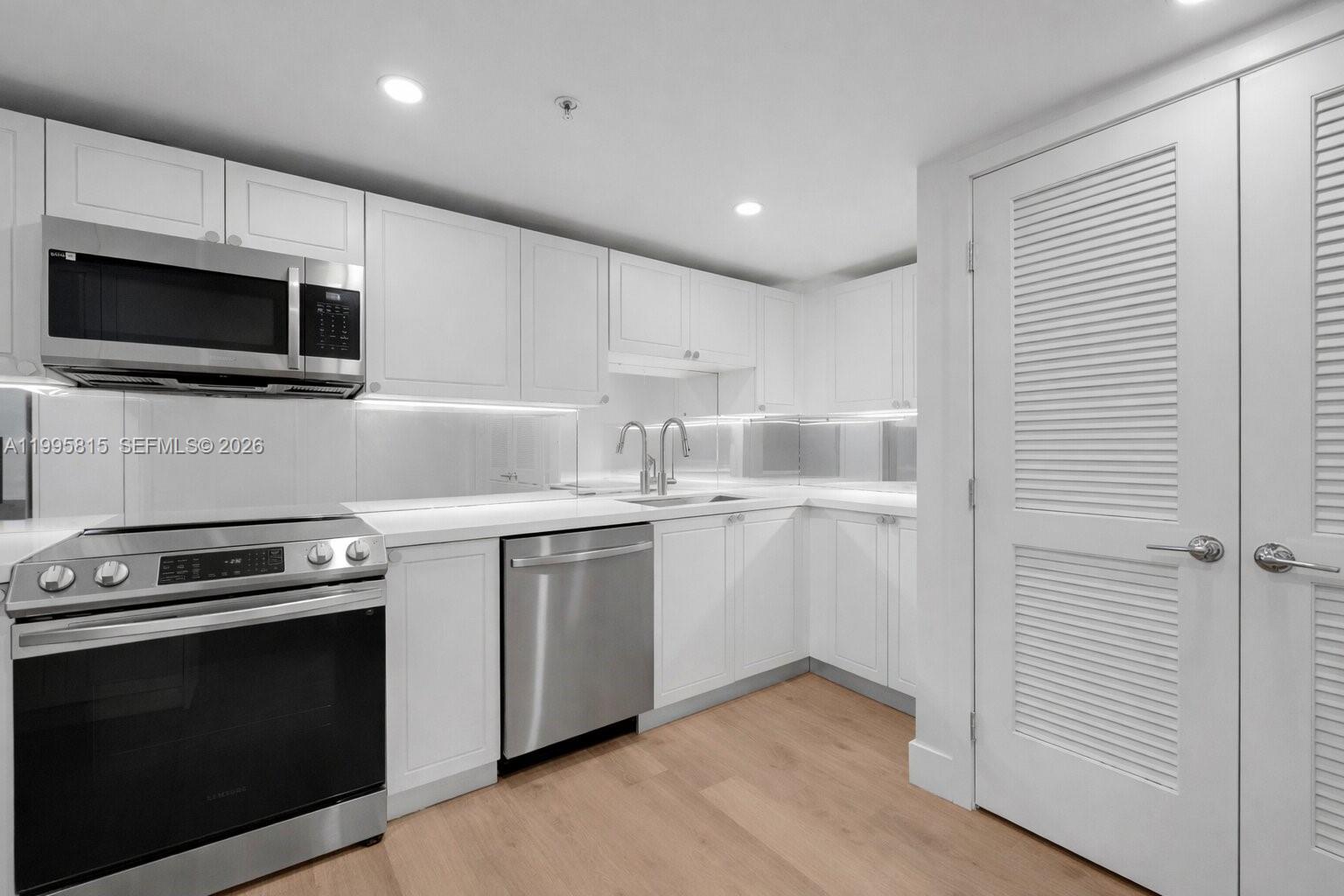 555 Northeast 34th Street, Unit 204 Miami, FL 33137 - Photo 12 of 31 a kitchen with a sink and steel appliances