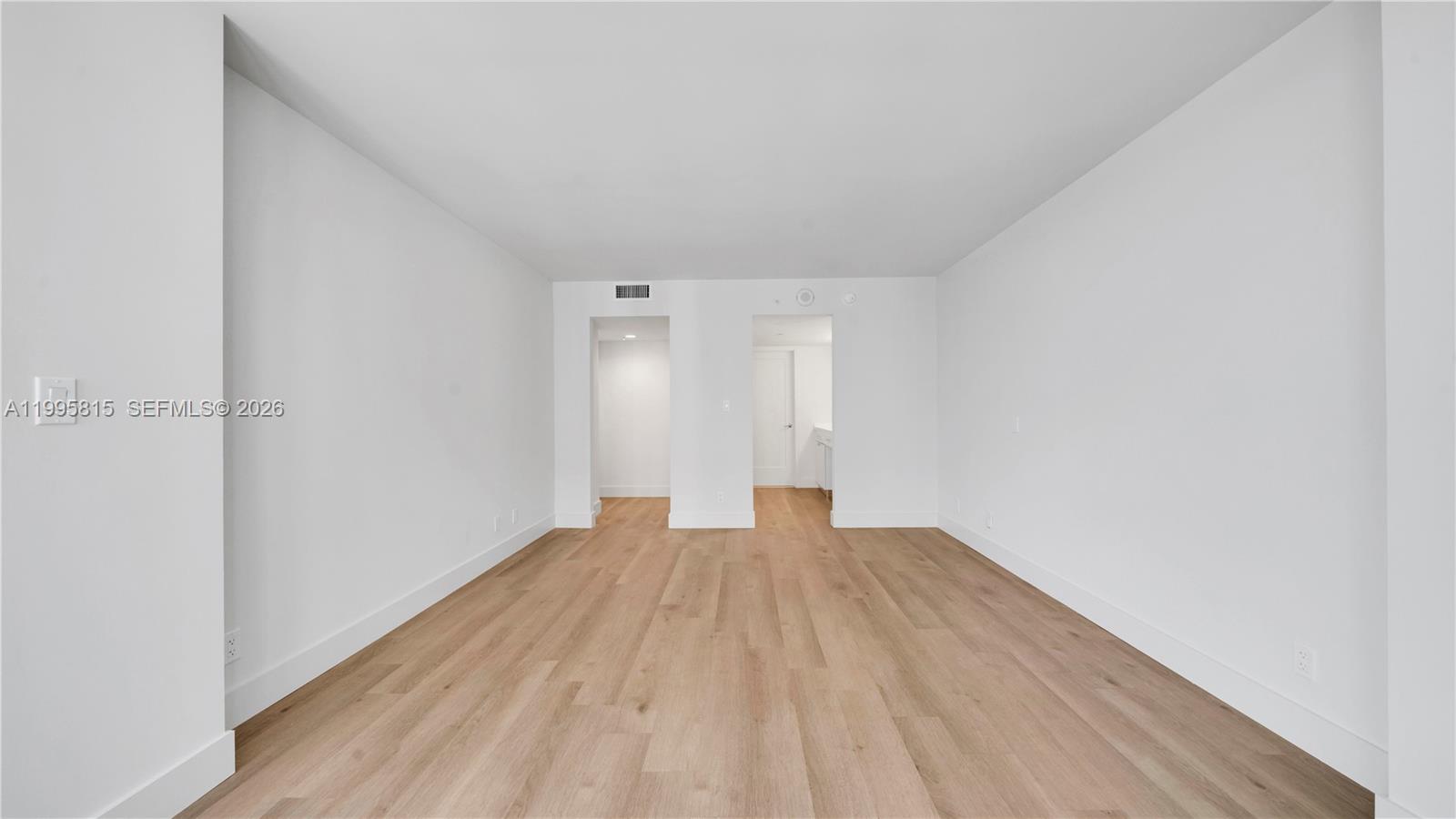 555 Northeast 34th Street, Unit 204 Miami, FL 33137 - Photo 15 of 31 a view of empty room with wooden floor