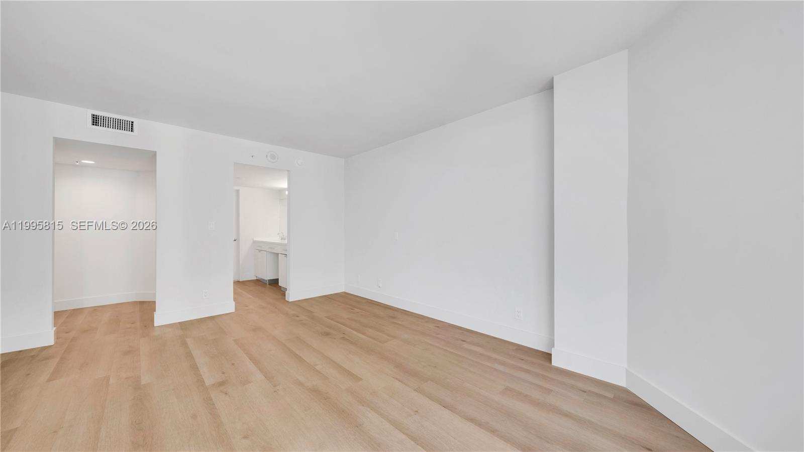 555 Northeast 34th Street, Unit 204 Miami, FL 33137 - Photo 16 of 31 a view of an empty room with wooden floor