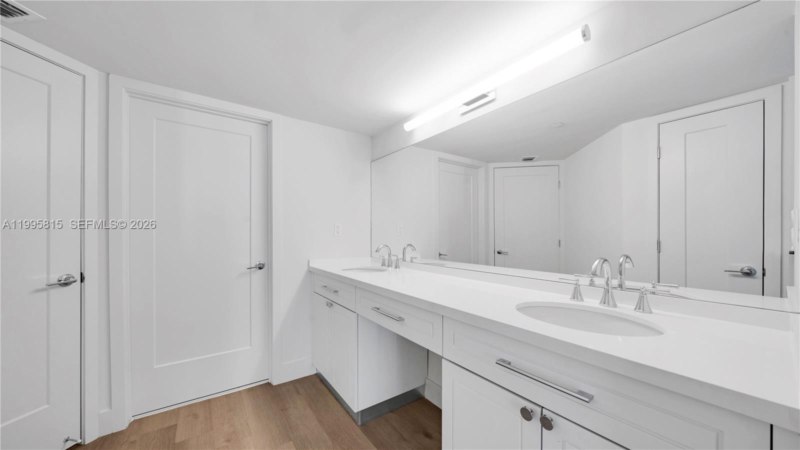 555 Northeast 34th Street, Unit 204 Miami, FL 33137 - Photo 18 of 31 a bathroom with a sink and a mirror