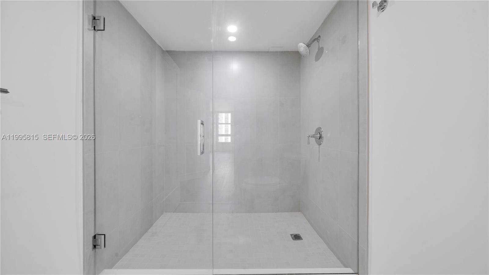 555 Northeast 34th Street, Unit 204 Miami, FL 33137 - Photo 21 of 31 a bathroom with a shower