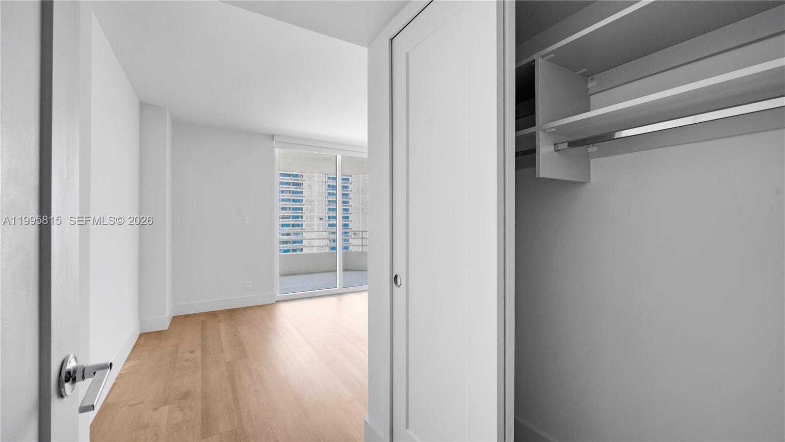 555 Northeast 34th Street, Unit 204 Miami, FL 33137 - Photo 27 of 31 a view of a hallway with wooden floor and closet