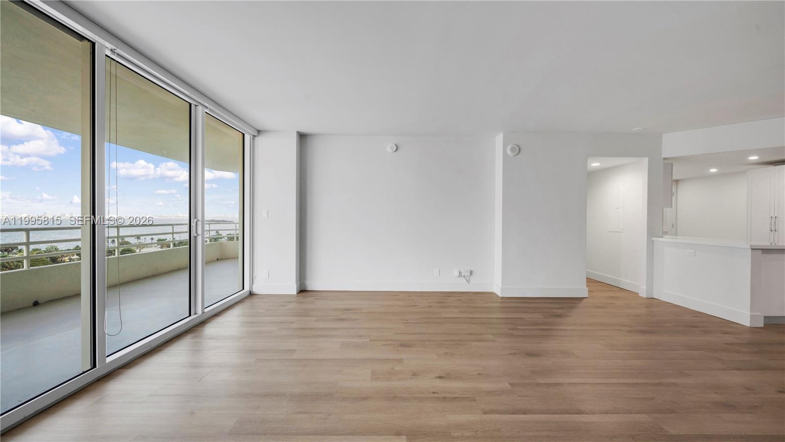 555 Northeast 34th Street, Unit 204 Miami, FL 33137 - Photo 9 of 31 a view of an empty room with glass door