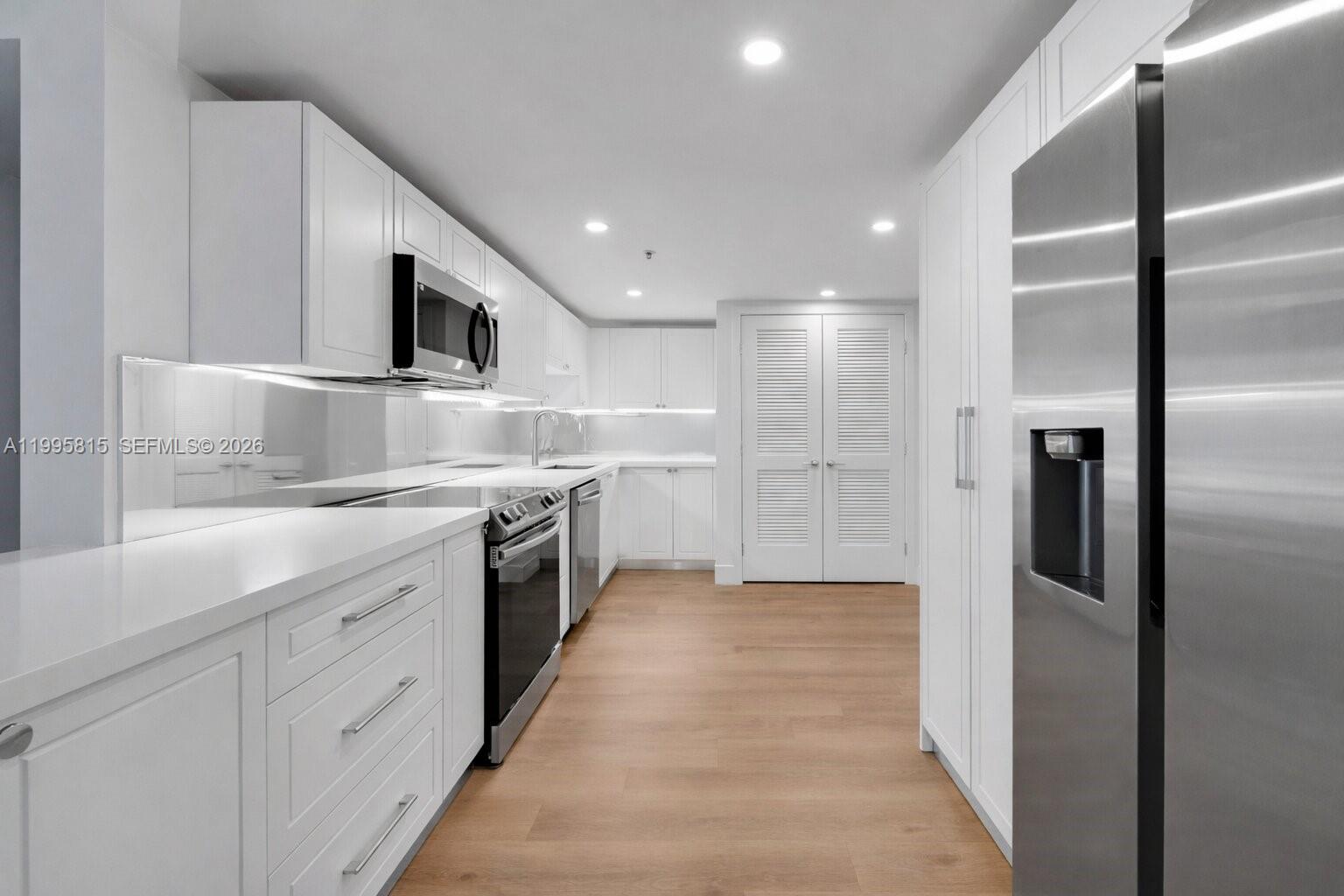 555 Northeast 34th Street, Unit 204 Miami, FL 33137 - Photo 10 of 31 a large kitchen with a sink and refrigerator