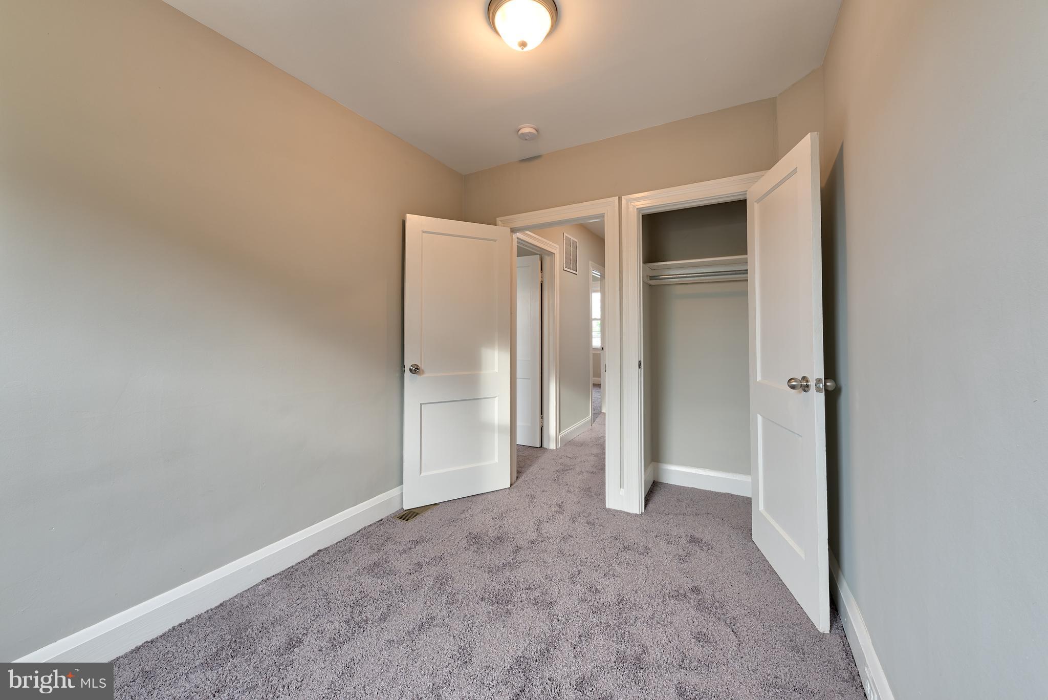 99 Willow Spring Road Baltimore, MD 21222 - Photo 21 of 30 an empty room with closet and mirror