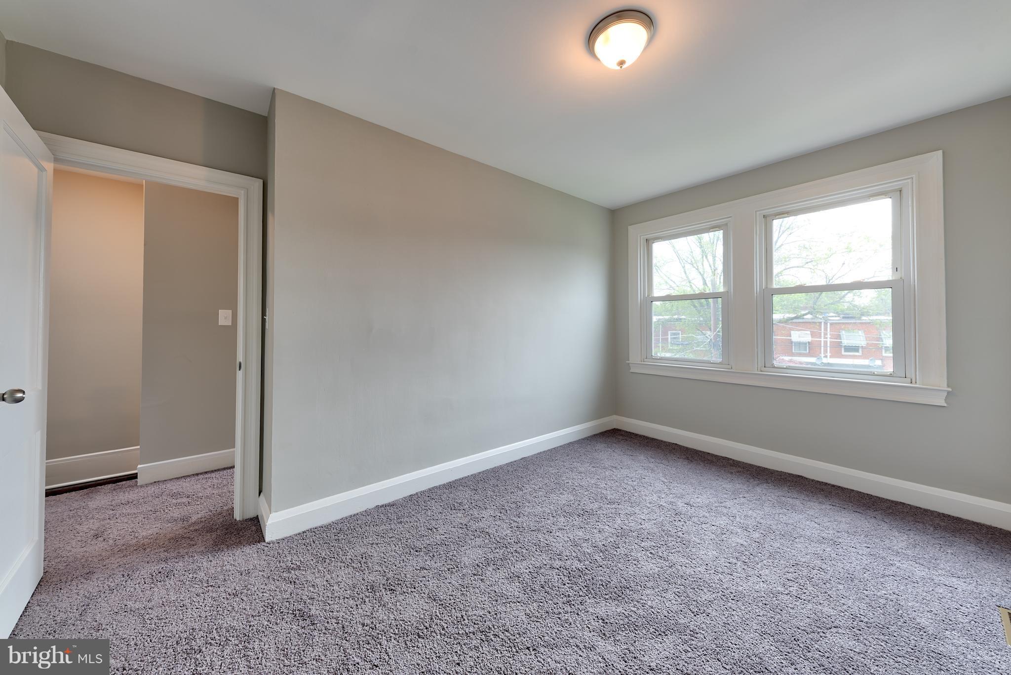 99 Willow Spring Road Baltimore, MD 21222 - Photo 23 of 30 an empty room with windows and closet