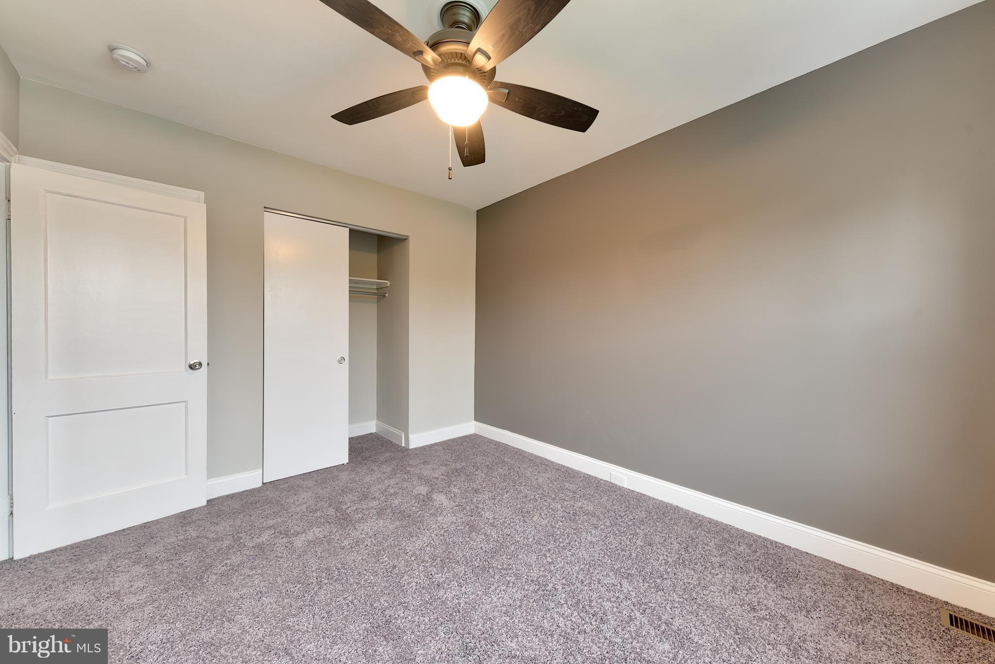 99 Willow Spring Road Baltimore, MD 21222 - Photo 27 of 30 an empty room with chandelier fan