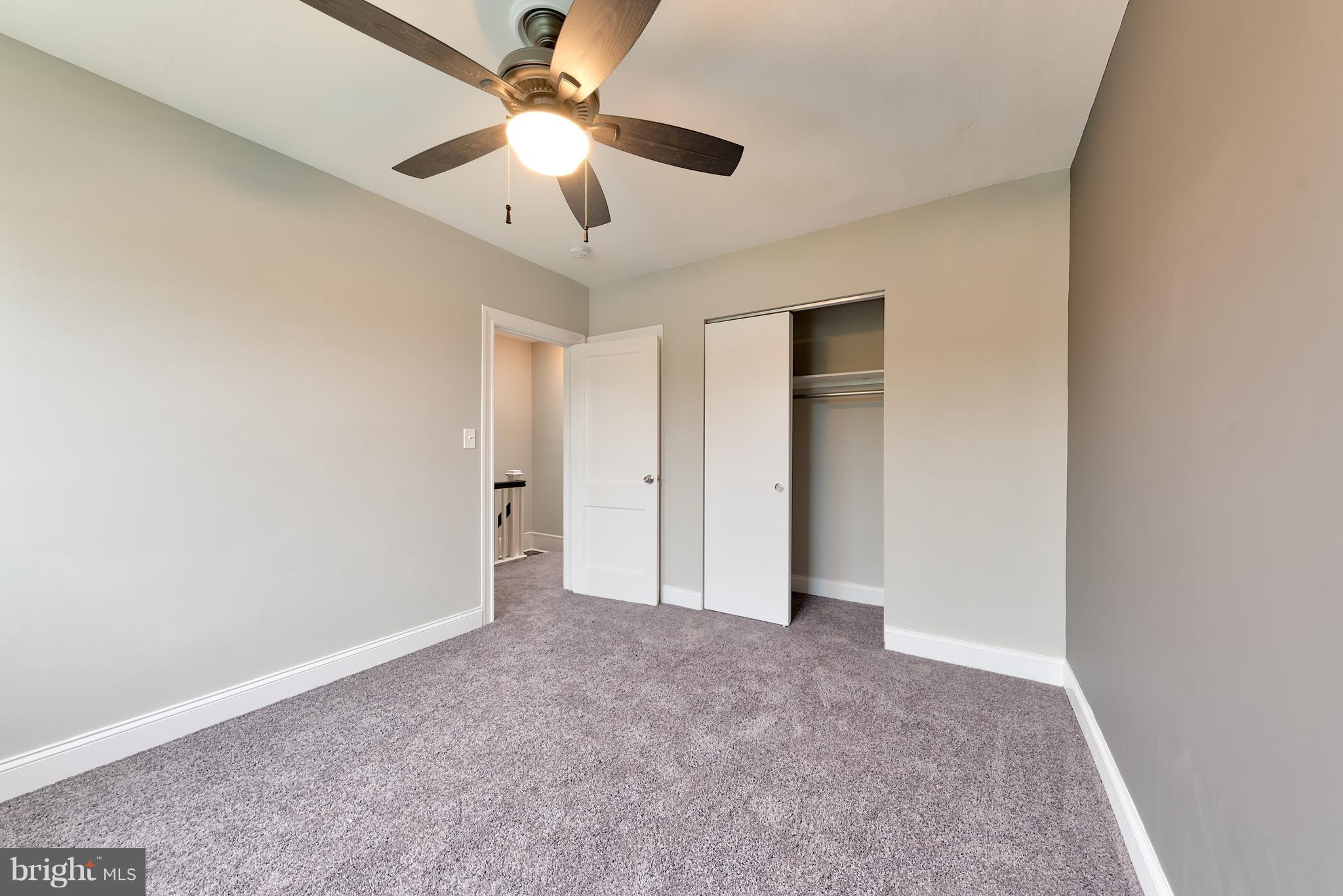 99 Willow Spring Road Baltimore, MD 21222 - Photo 28 of 30 an empty room with chandelier fan and closet