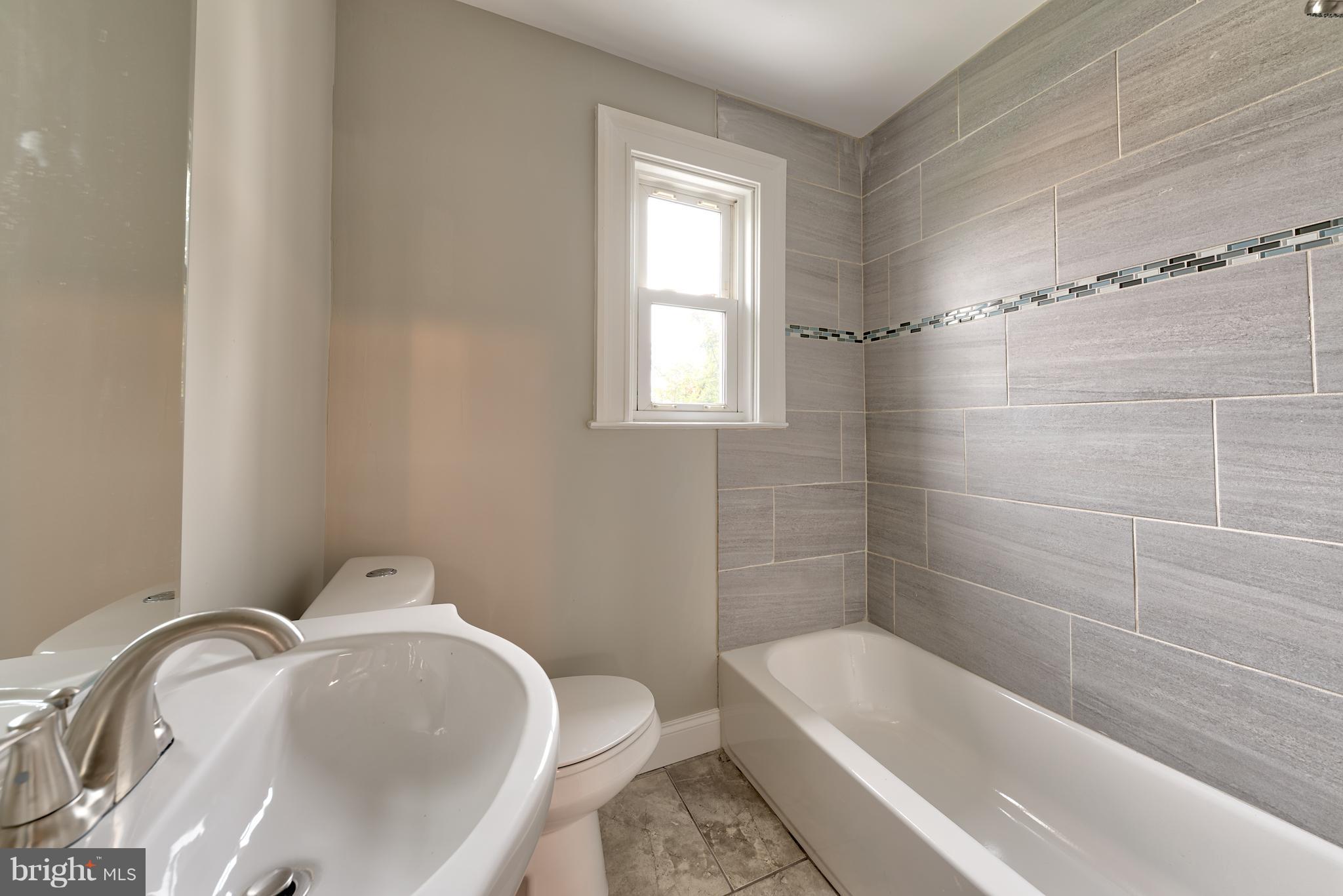 99 Willow Spring Road Baltimore, MD 21222 - Photo 30 of 30 a bathroom with a tub sink and toilet
