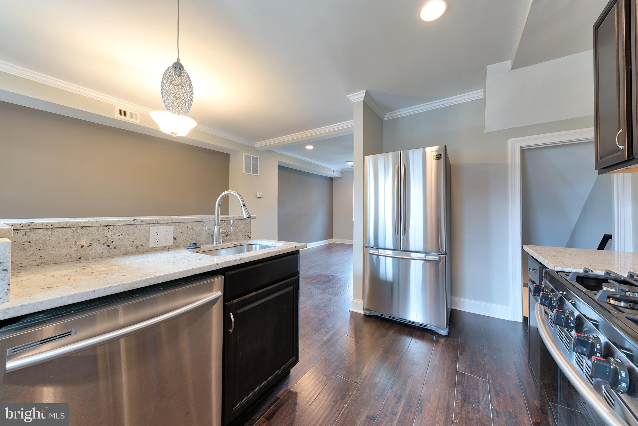 99 Willow Spring Road Baltimore, MD 21222 - Photo 10 of 30 a kitchen with stainless steel appliances a sink and a refrigerator