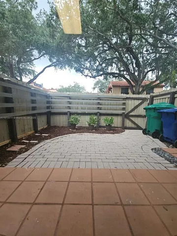 a view of a yard and chair in front of house