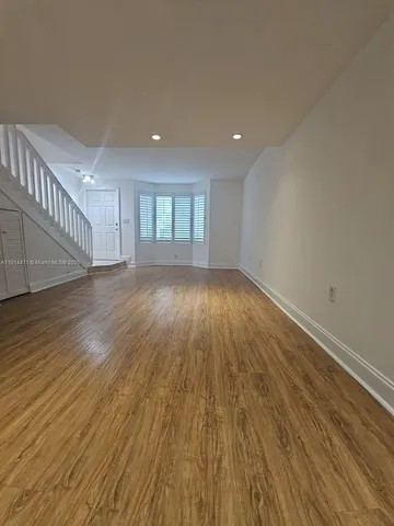 a view of an empty room and wooden floor