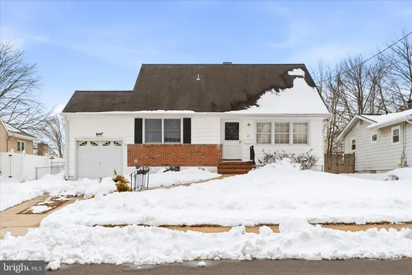 a view of a white house with a yard covered in snow