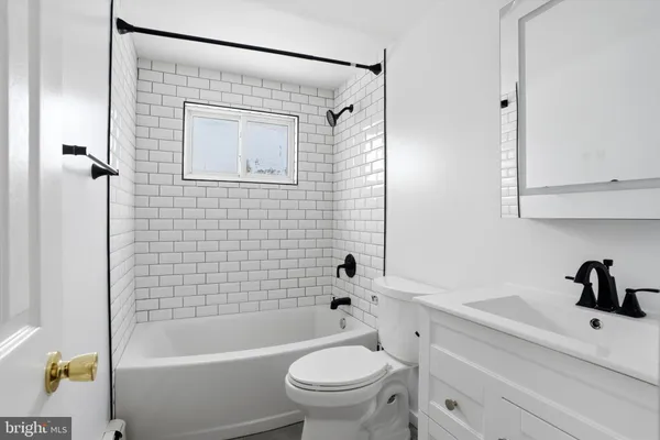 a bathroom with a sink a toilet and a bathtub