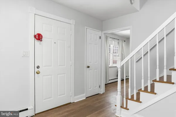 a view of entryway and hall with wooden floor