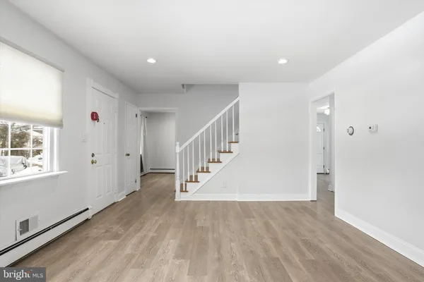 a view of an entryway with wooden floor